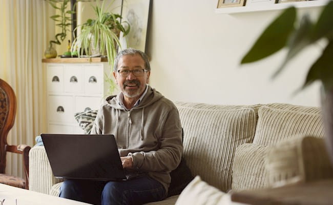 Man with laptop on couch